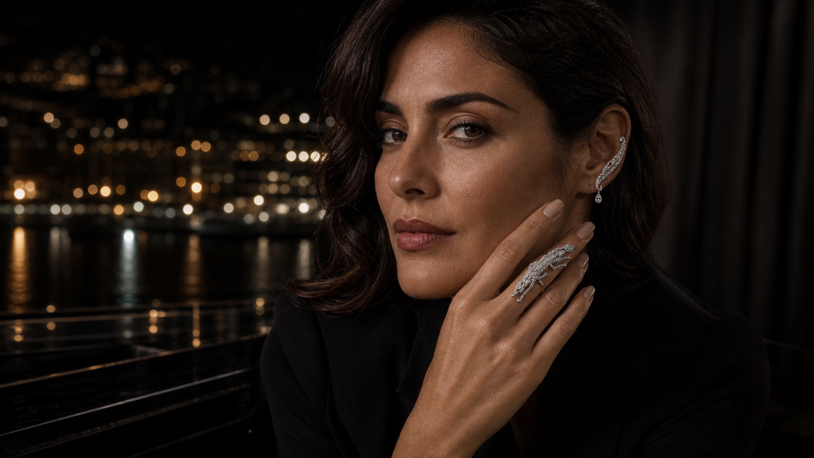 Close study of a dark-haired woman wearing the articulated FELIS panther ear climber and long panther ring.